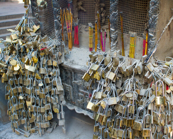 At a temple in Shandong province, hundreds of small metal locks are affixed to a Chinese cauldron (called a “ding”) with offerings of incense nearby. Engaged couples visit temples to place the locks, engraved with their names, and monks perform a ritual intended to “bind” the couples’ love for all eternity.