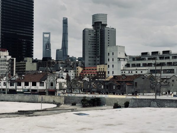 Urban skyline with buildings from different periods layered like geological strata