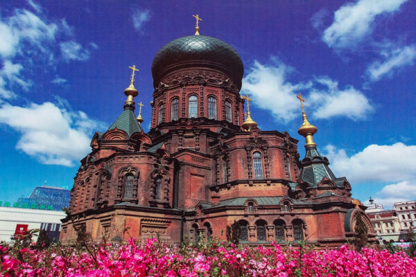 The red brick walls, green domes, and golden crosses of Saint Sophia Cathedral (a former Russian Orthodox church in Harbin, China, built in Russian revival architectural style) call to mind Moscow’s Red Square.