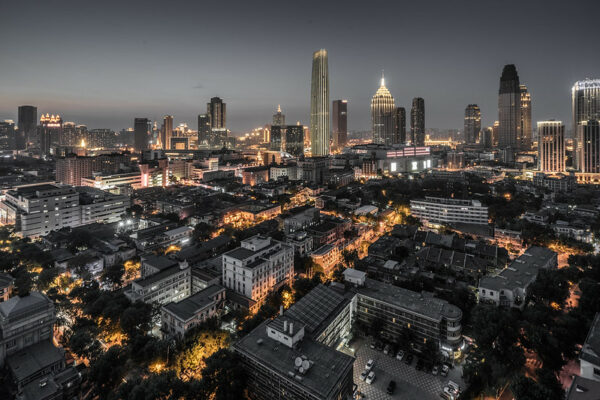 A dramatic gold- and black-tinted panorama of Tianjin’s skyline at dusk.