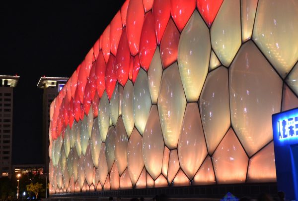 The exterior "bubbles" of Beijing’s famed Water Cube aquatic center, which will host curling in the 2022 Winter Olympics, are illuminated in red and gold, rather than in the blue hues that prevailed during the 2008 Beijing Olympics.